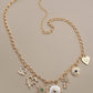 CHARM NECKLACE-HEART CROSS SUNBURST STONE